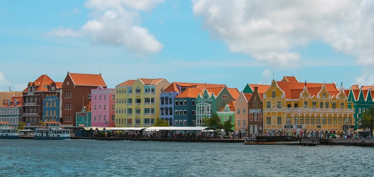 moving to curacao oceanside colorful buildings sunny day